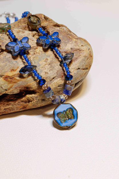 vintage handmade enchanted blue butterfly dance bead necklace on stone